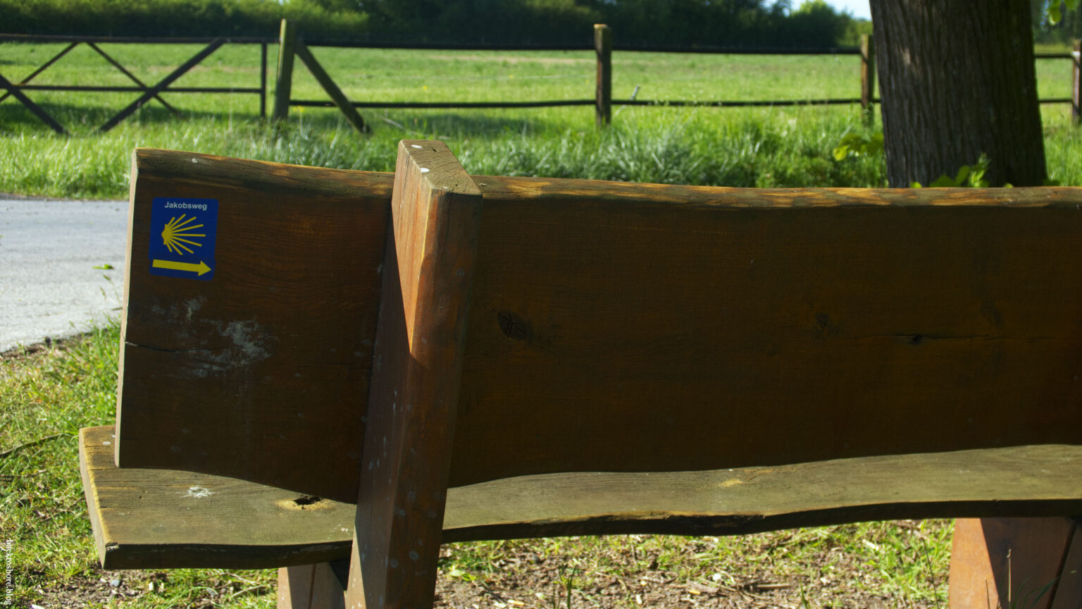 Waymarker on the back of a bench