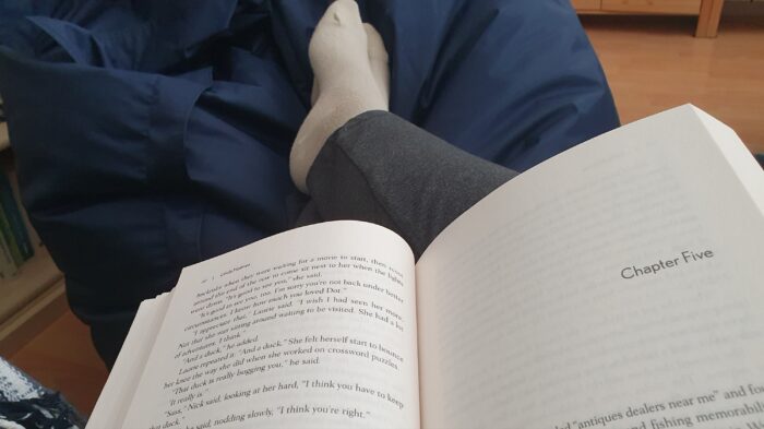an open book, legs in compression stockings