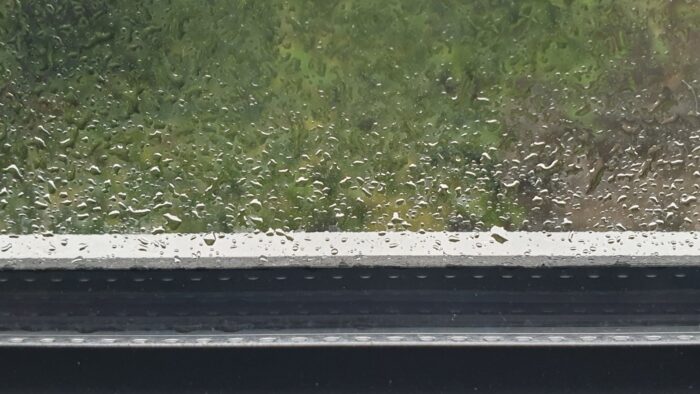 Windowpane with raindrops at the bottom
