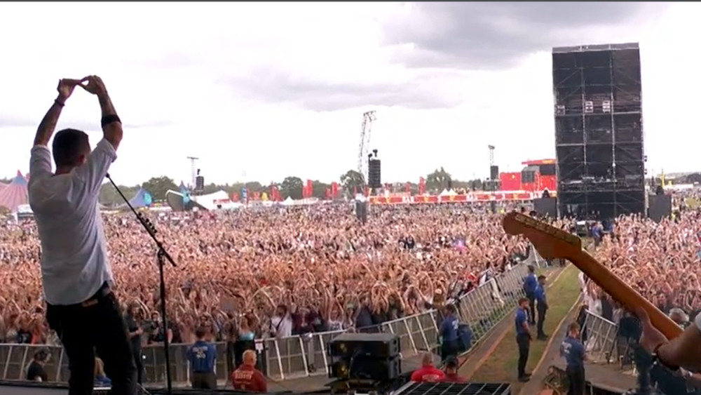 Screenshot Reading Festival stream. Frank Turner on stage with a twirling audience in the background