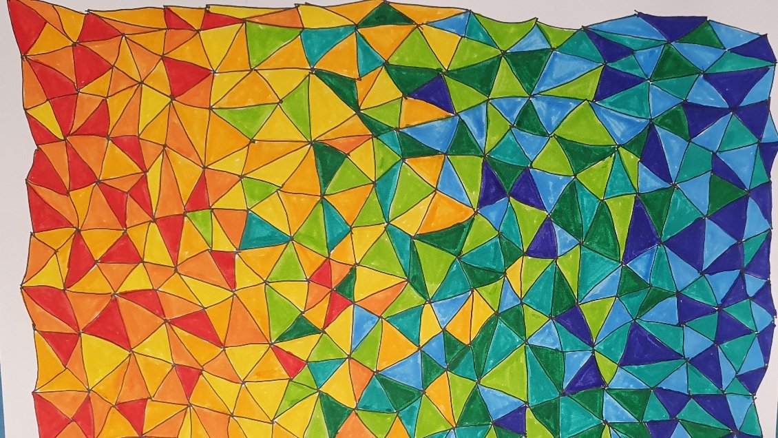 Picture of a page filled with small triangles, coloured in a variety of colours from red, orange, yellow, shades of green and blue