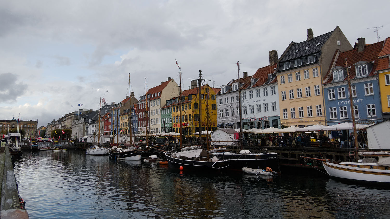 Photo of Nyhavn, Copenhagen: sailboats docked, colourful houses in the background