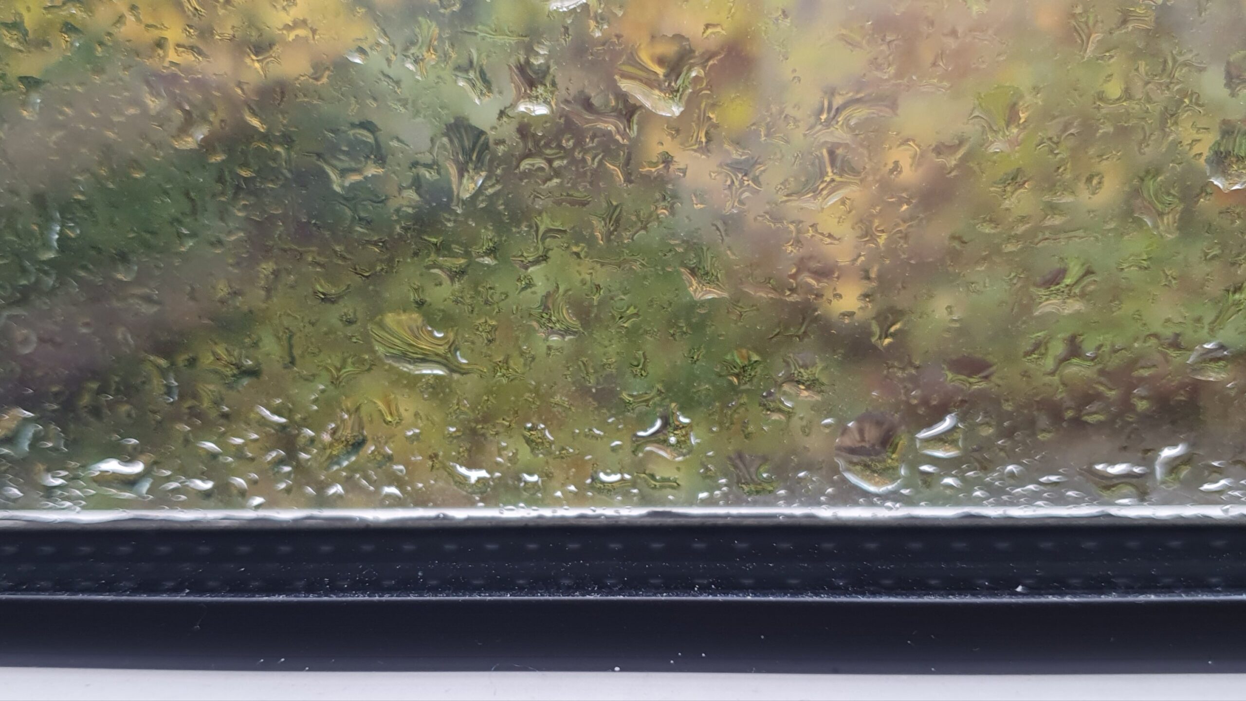 view of the bottom of a window, raindrops on the pane