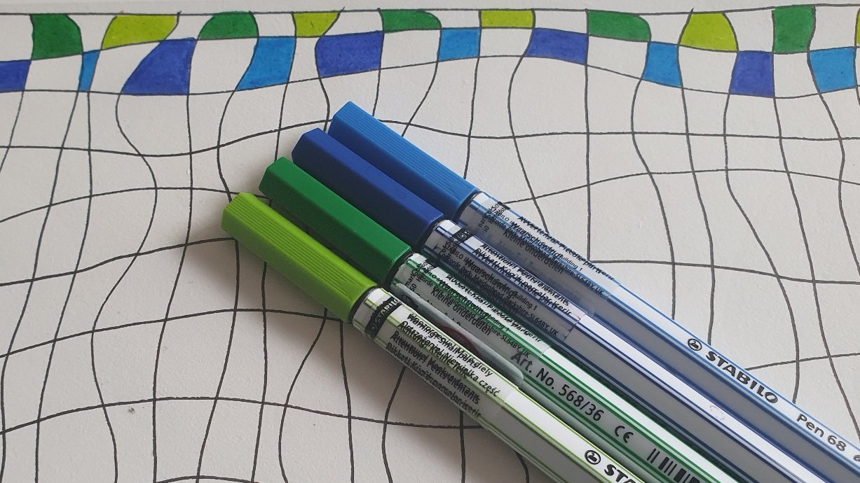 Photo of a drawing of crooked horizontal and vertical lines. Every other square in the first two lines in filled in with shades of blue or green