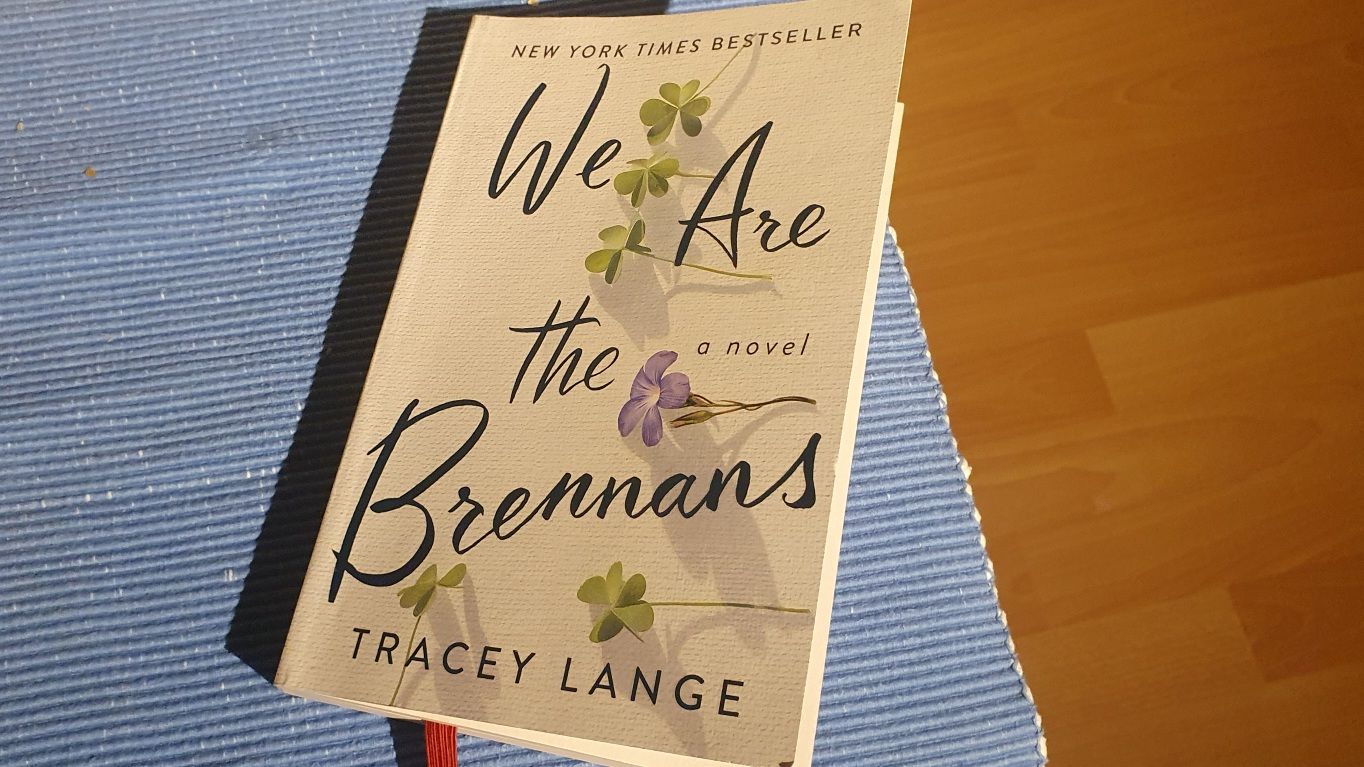 Photo of a paperback edition of "We Are the Brannons" on a blue cloth