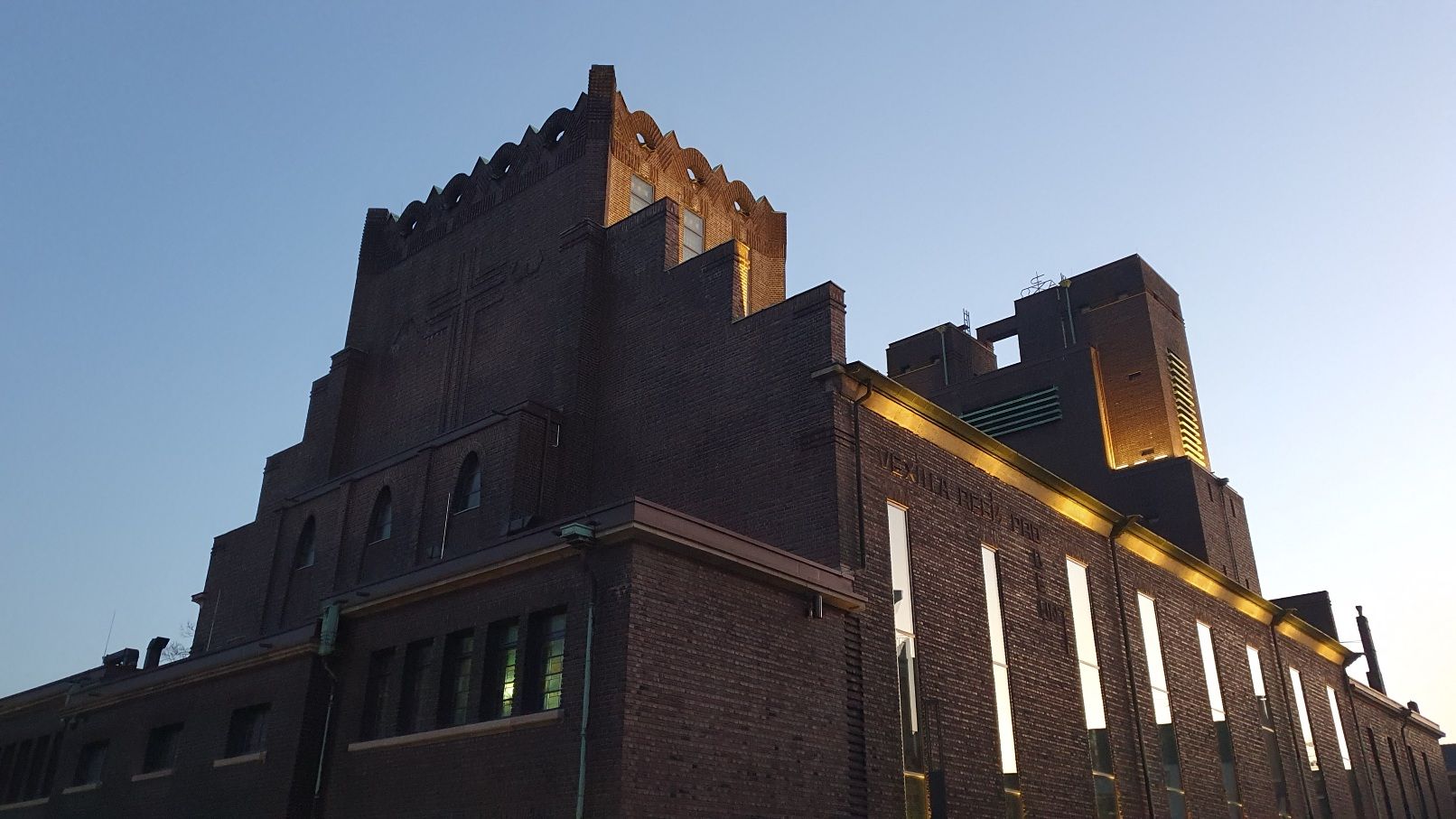 Photo of a Brick Expressionism church, under a wintery blue sky