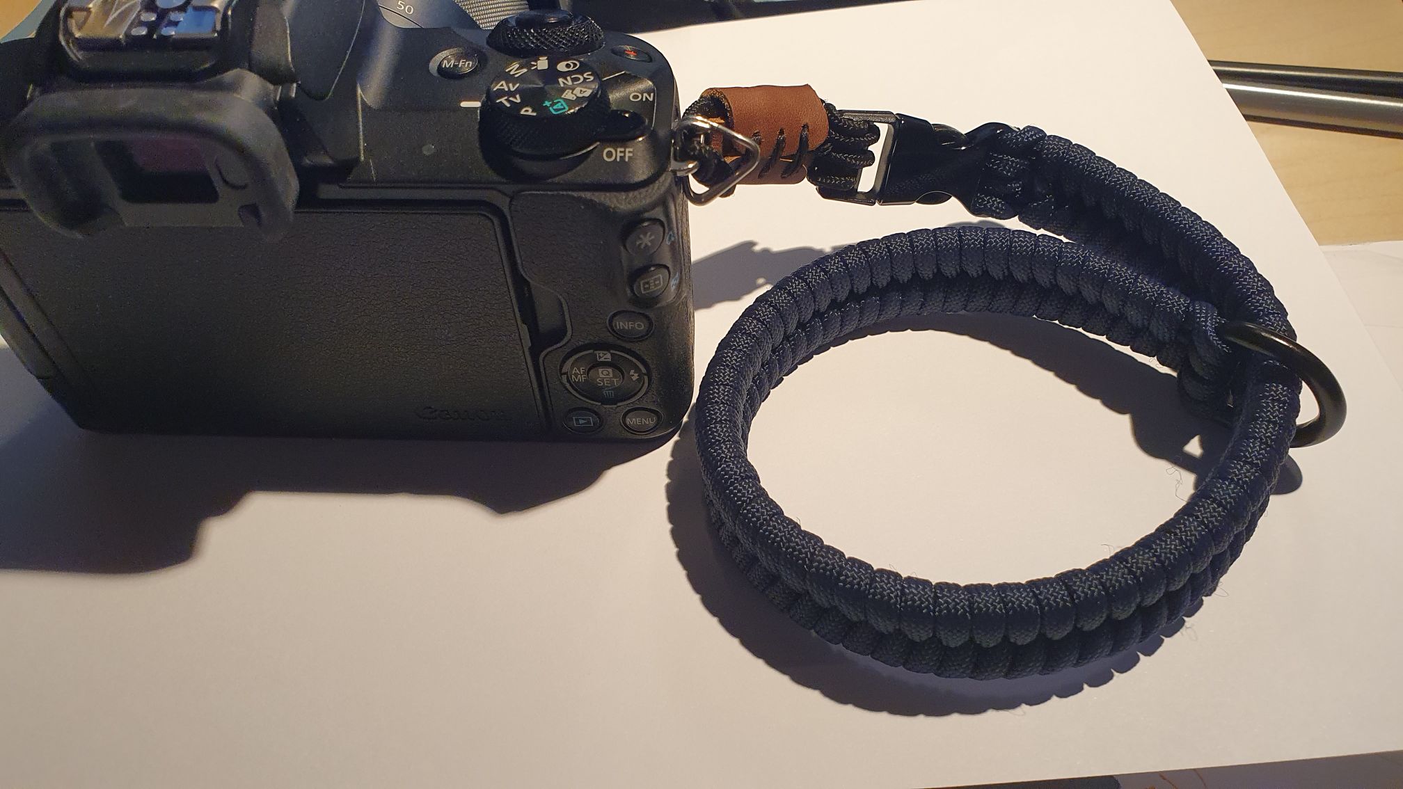 Camera with an attached wrist strap