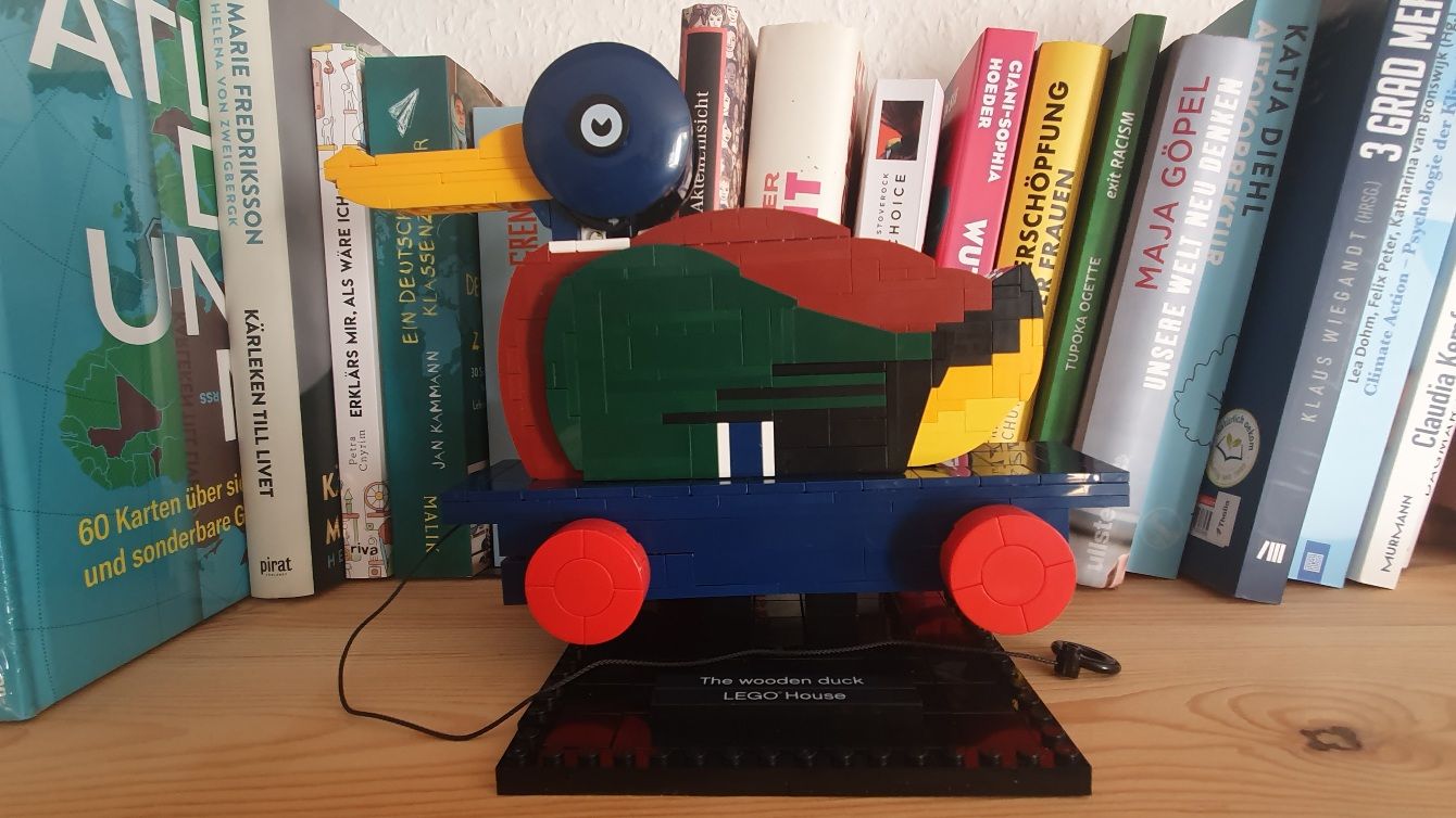 Photo of the LEGO duck in front of books