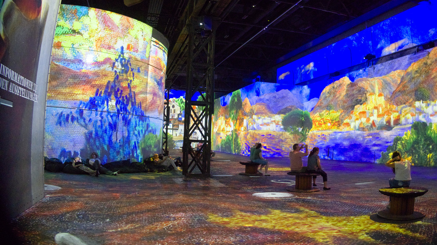 Inside a spacious former industrial space, colourful Dali art images projected on the walls