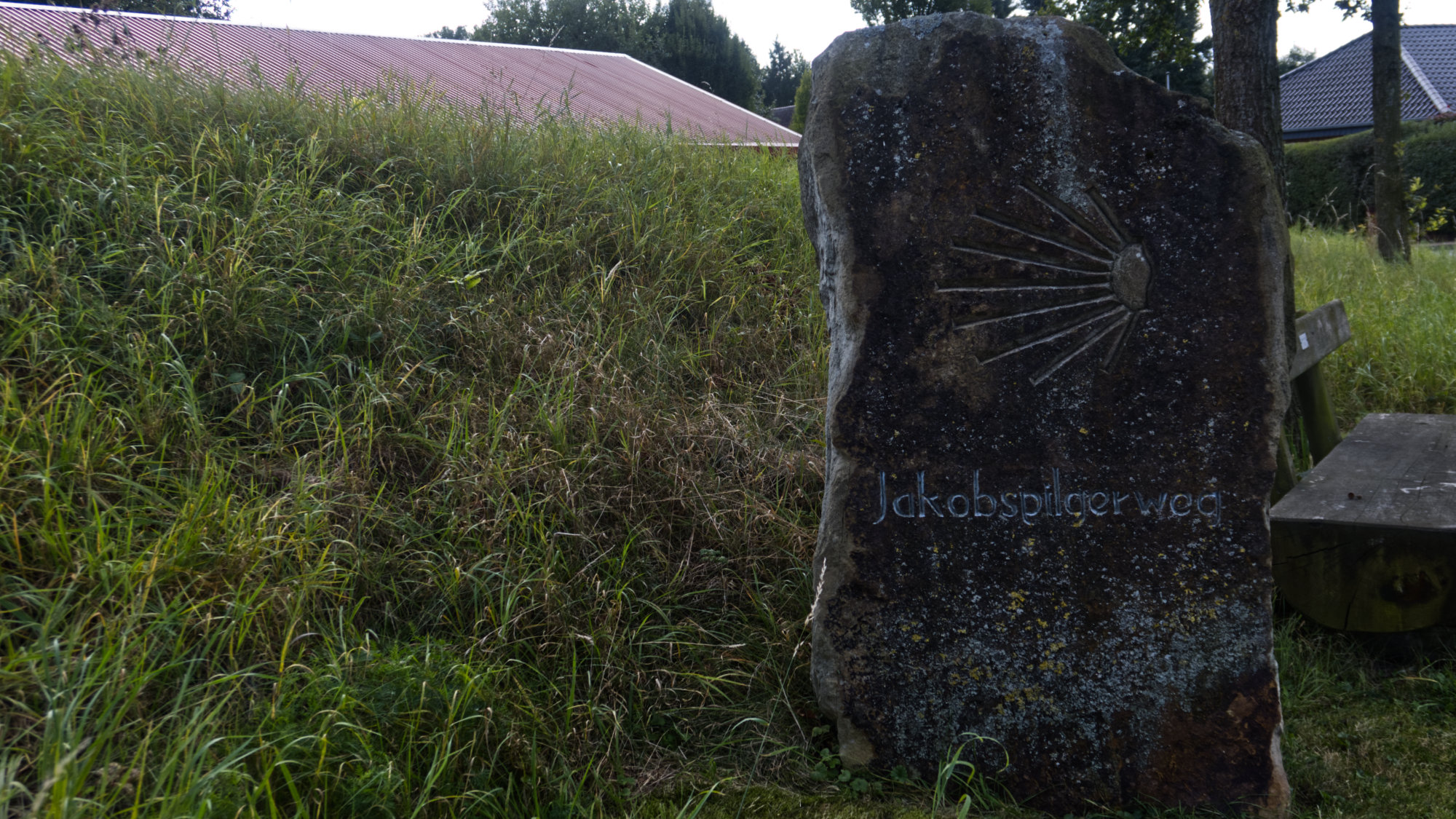 Stone with (German) "Pilgrim's Way of St James" and the shell symbol inscription