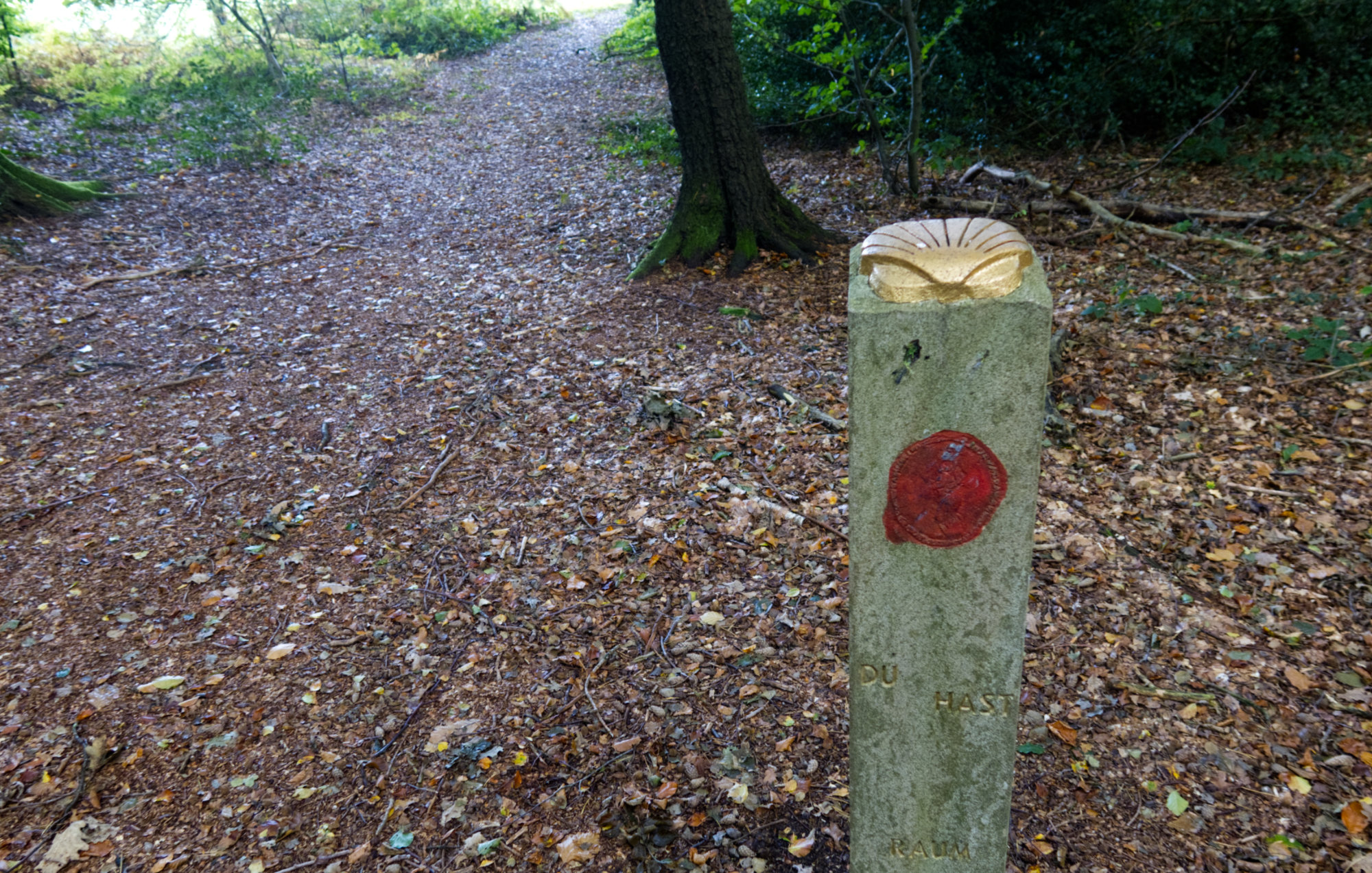 Stele with a scallop and some art, forest ground