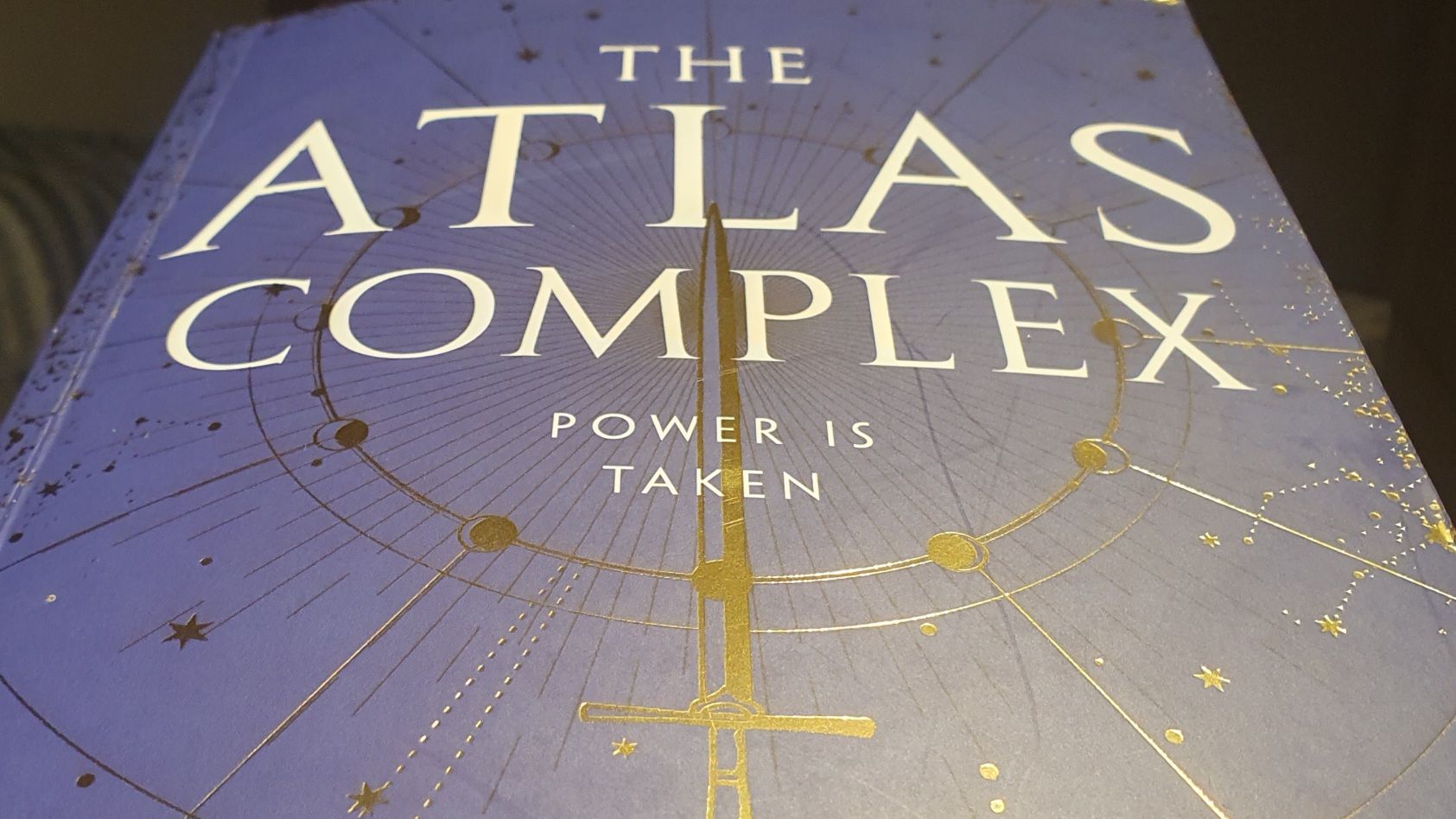 Close up of the blue cover of "The Atlas Complex" novel