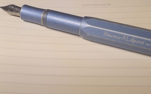 Kaweco Sports Fountain pen in denim metalic lying on an empty open journal page