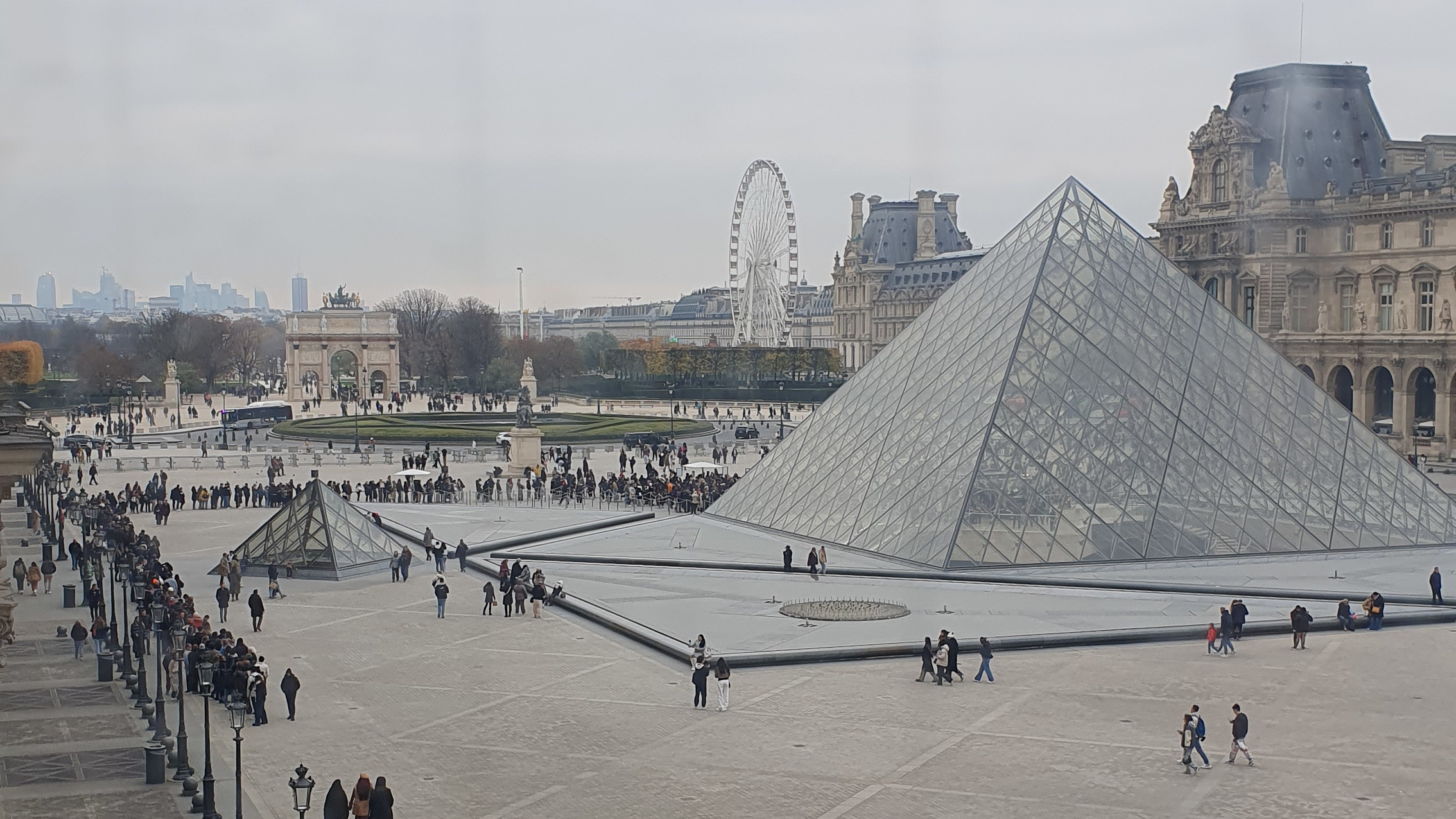 Queue outside the Louvre snaking around the Pyramid entrance