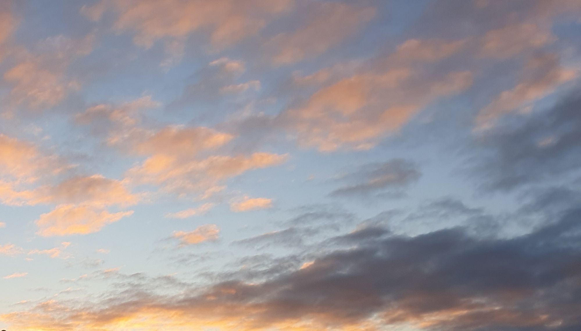 Clouds at sunrise, lower right corner has leftover dark clouds from the storm