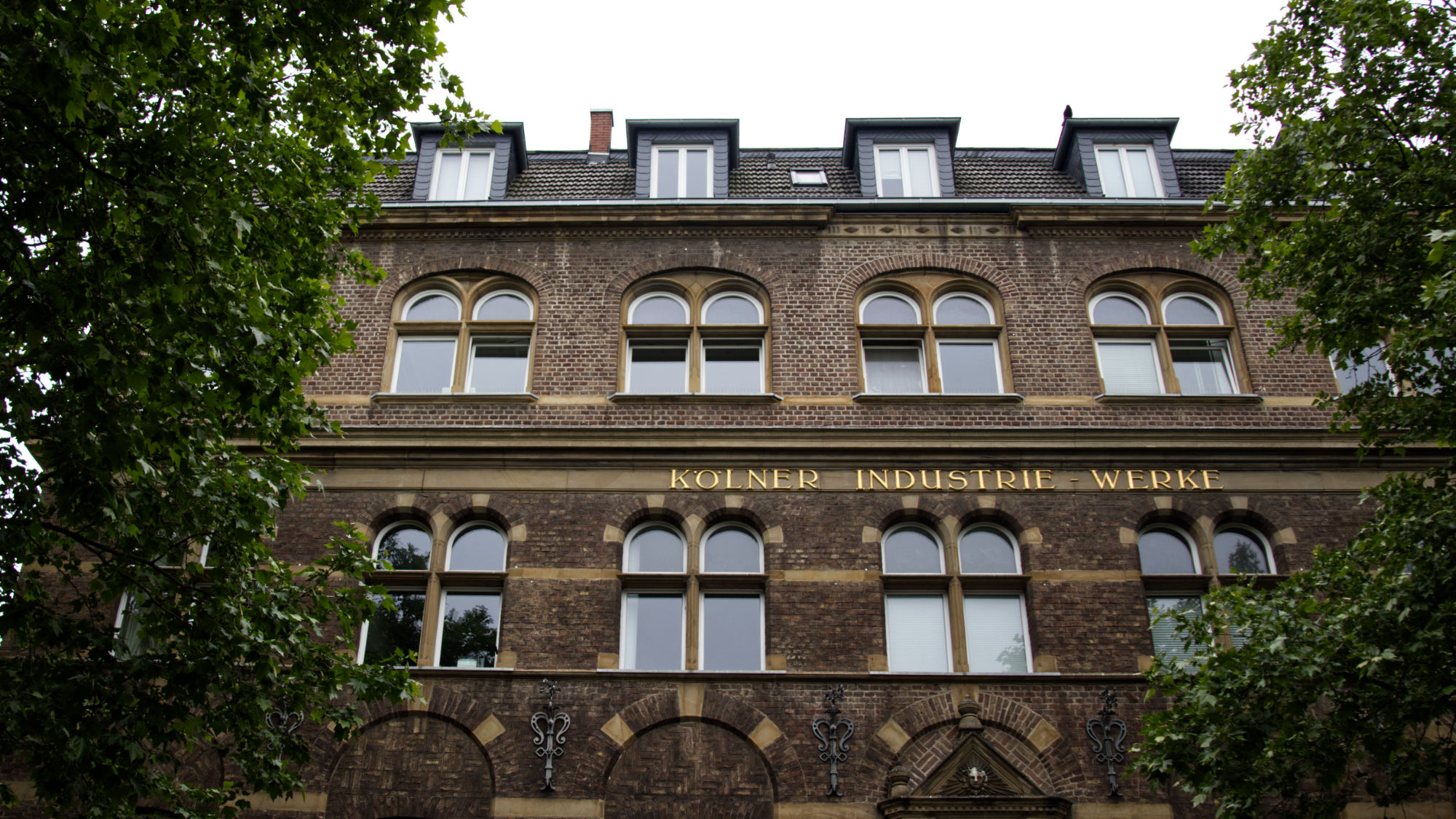 Brick Building with "Kölner Industrie Werke" in golden letters
