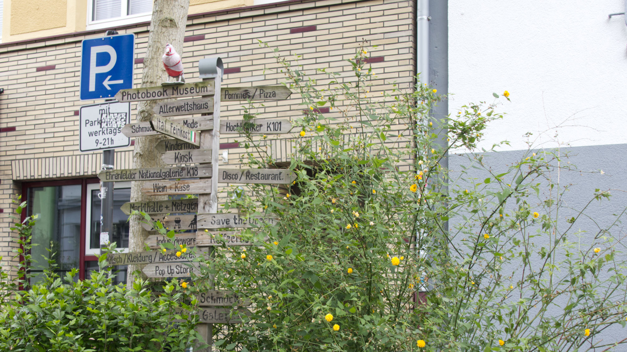 Wooden signpost to shops, venues, eateries