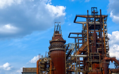 Rusty old blast furnace with a blue sky