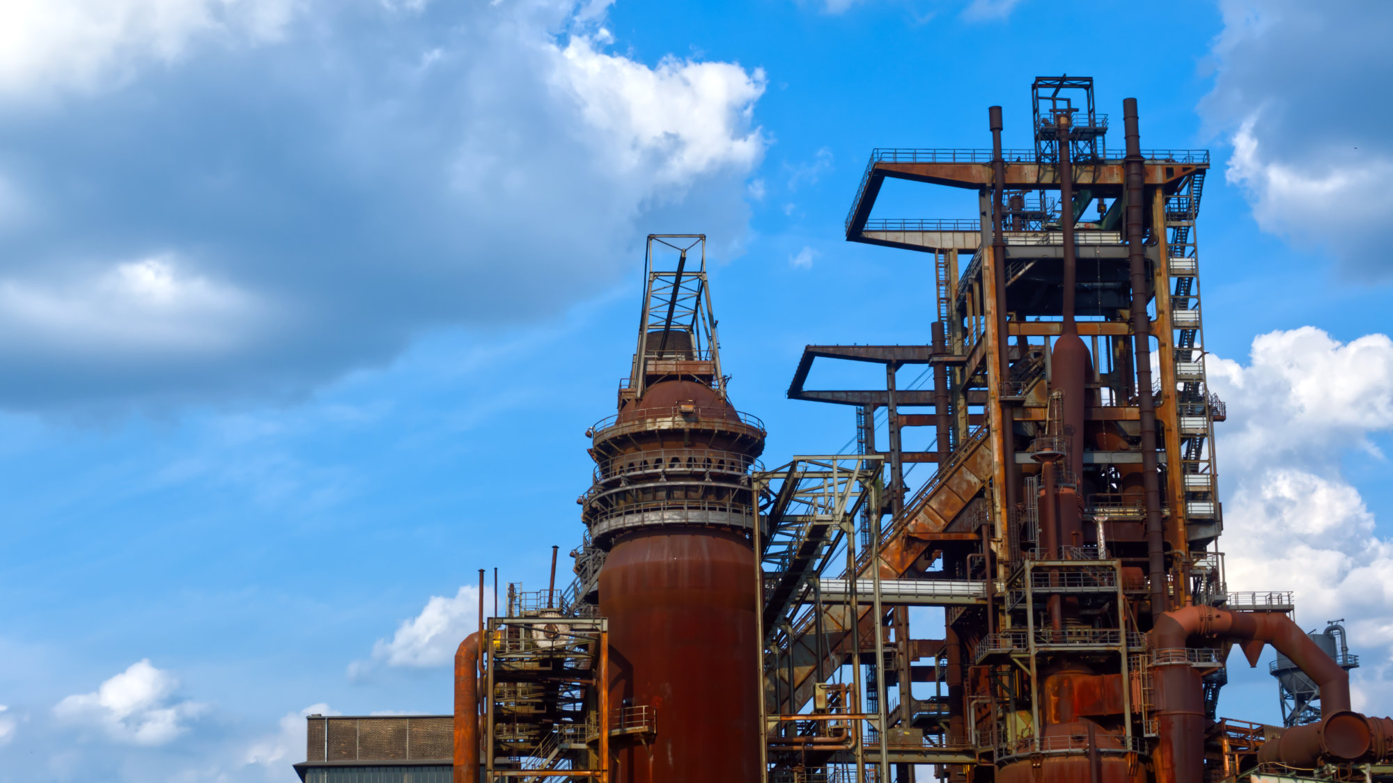Rusty old blast furnace with a blue sky