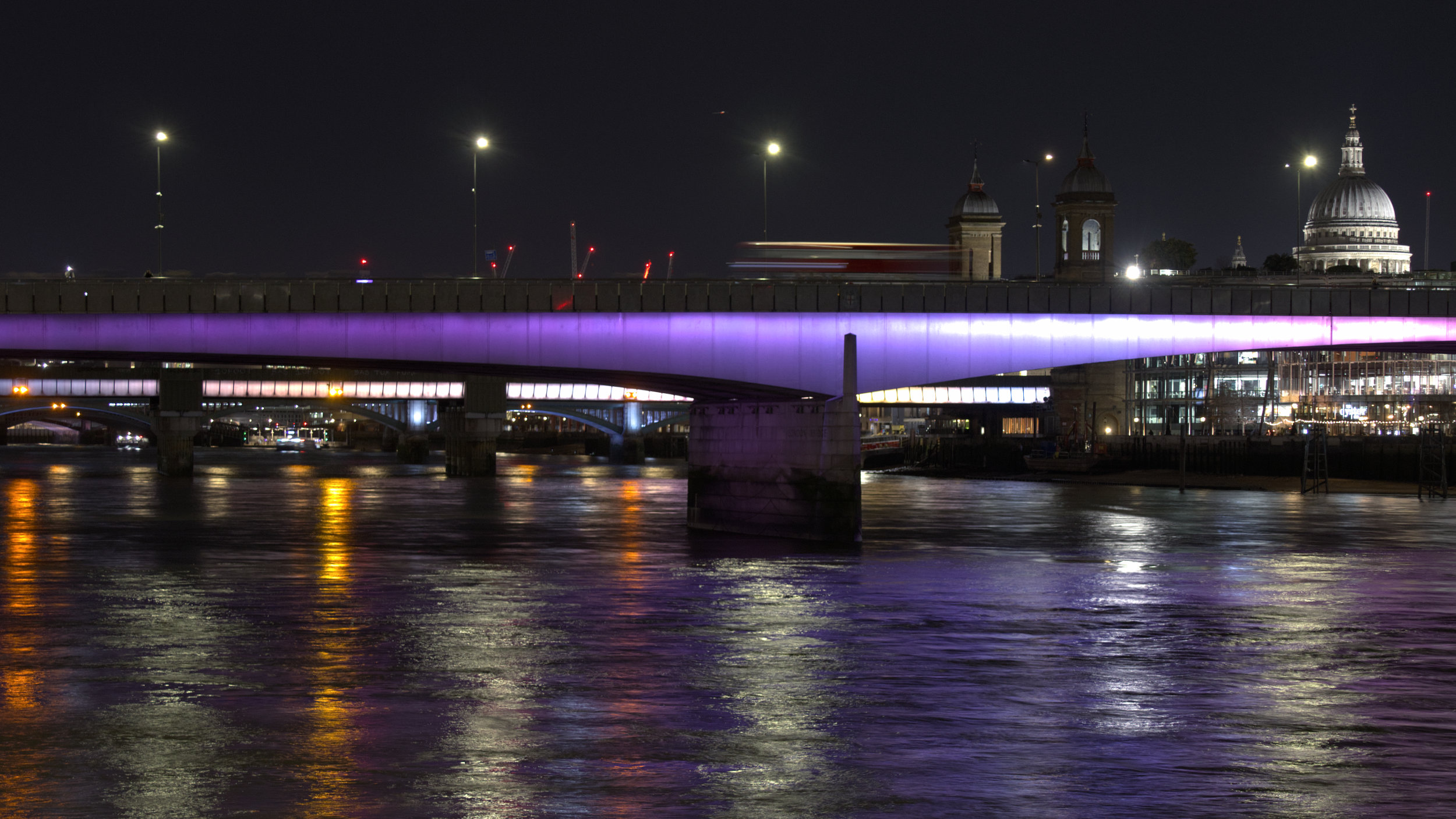 St. Pauls and illuminated London Bridge by night